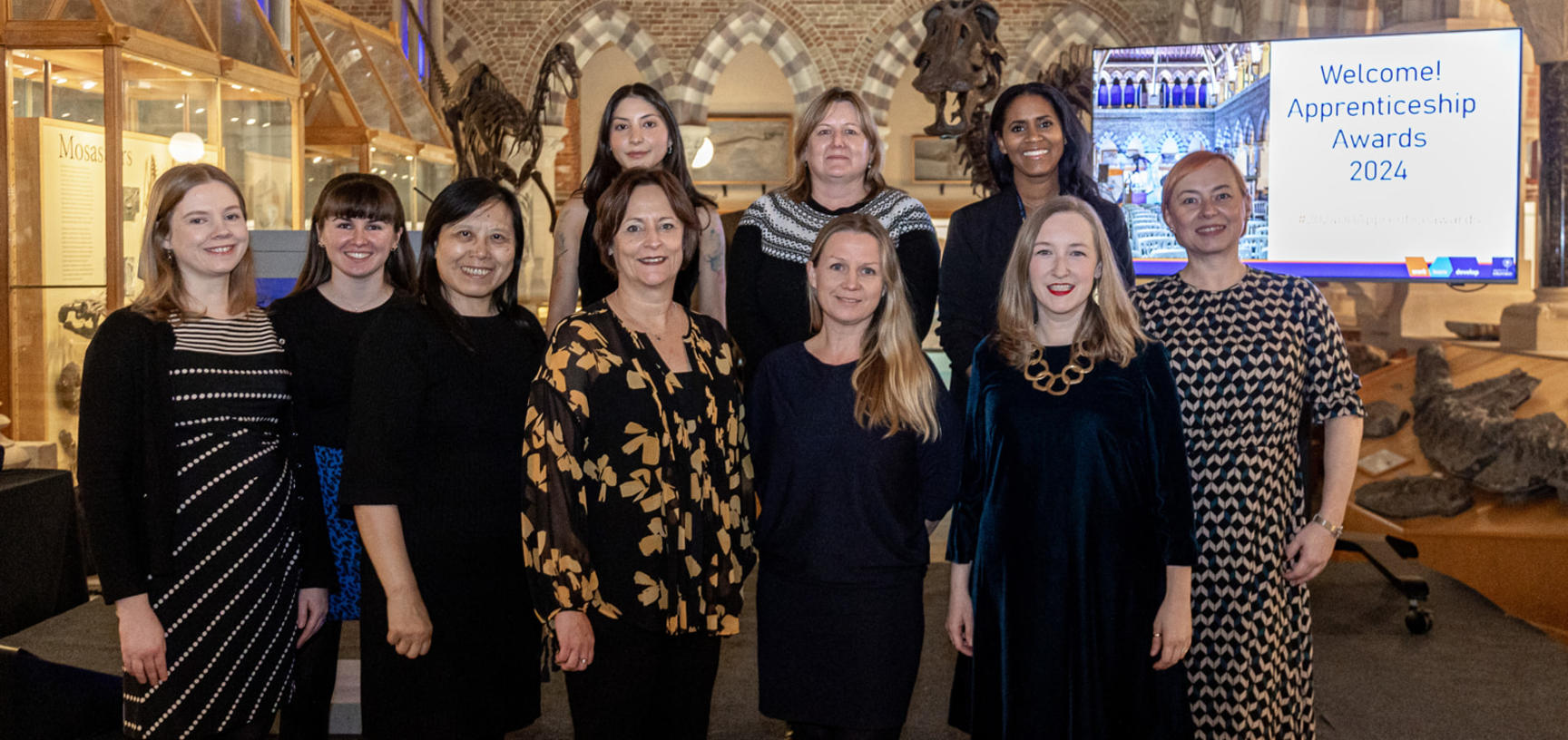 University laboratory technician apprentices holding the Apprenticeship ambassador flag during National Apprenticeship Week 2019